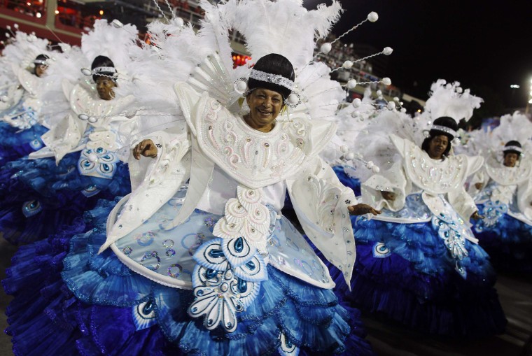 Image: Revellers participate on the first night of the annual carnival parade in Rio de Janeiro's Sambadrome