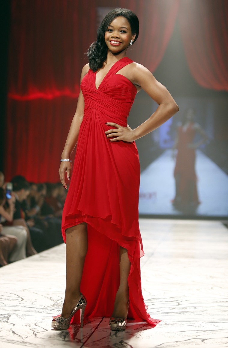 Image: US Olympian Gabby Douglas presents a creation during the The Heart Truth's Red Dress Collection fashion show in New York