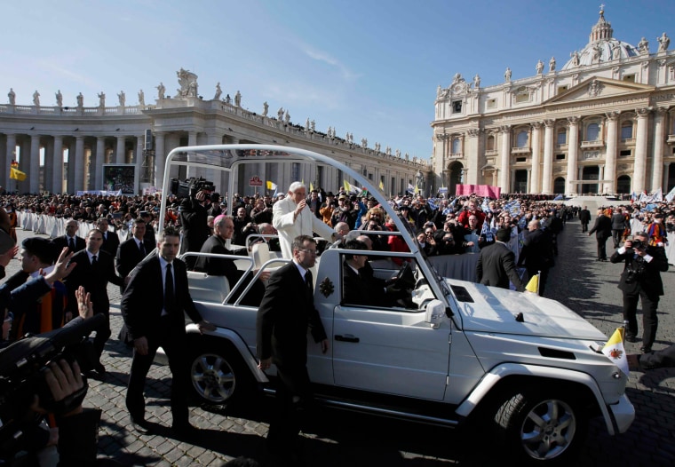 Image: Pope Benedict XVI waves to the faithful after arriving in St Peter's Square to hold his last general audience at the Vatican
