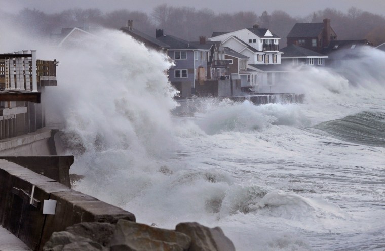Image: Waves crashing over a seawall in Scituate, Mass.