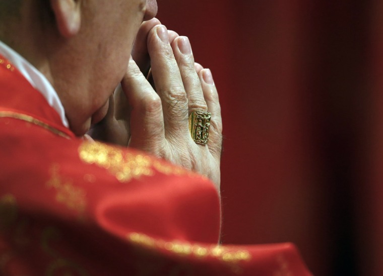 Image: A Cardinal prays during a mass in St. Peter's Basilica at the Vatican