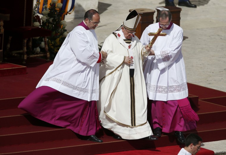 Image: Pope Francis descends the stairs as he takes part in his inaugural mass in Saint Peter's Square at the Vatican