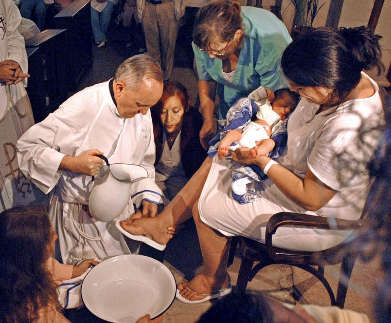 File photo of Argentine Cardinal Bergoglio washing the feet of a woman on Holy Thursday.