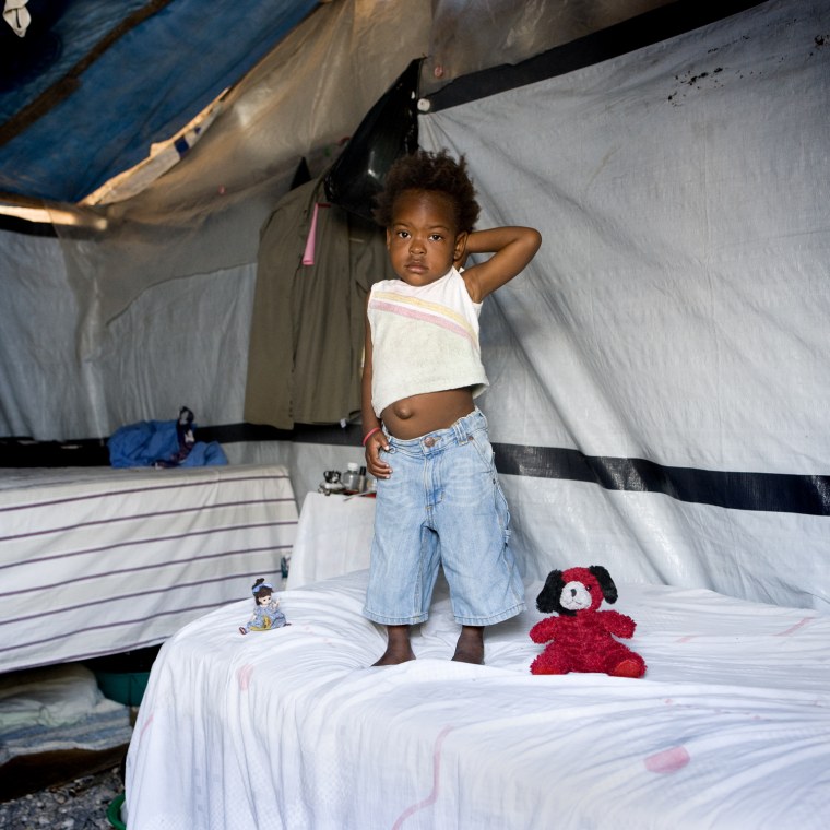 Samantha, 3 years old -  Port-au-Prince, Haiti
Samatha used to live in a house in the center of the city, then after the earthquake she moved in a tent together with the whole family because they lost the house.
She doesn't have many toys, actually she has just two little dolls.
