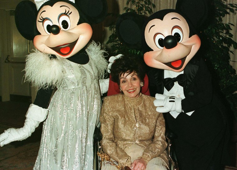 Image: File photo of actress Annette Funicello posing with Mickey and Minnie Mouse