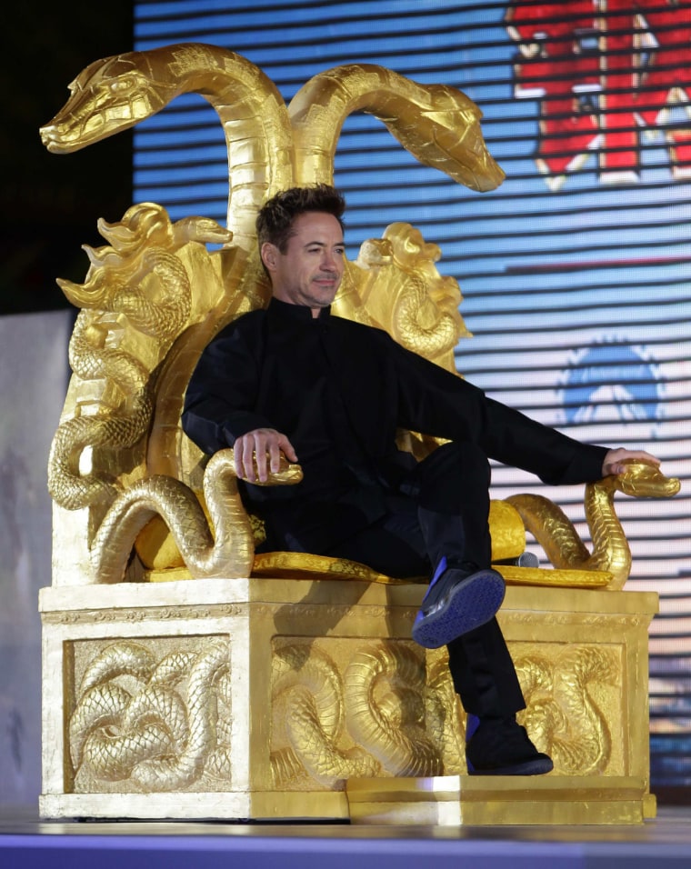 Image: Cast member Downey Jr. sits on a chair during a promotional event for Hollywood movie ''Iron Man 3'' at the Imperial Ancestral Temple of Beijing's Forbidden City