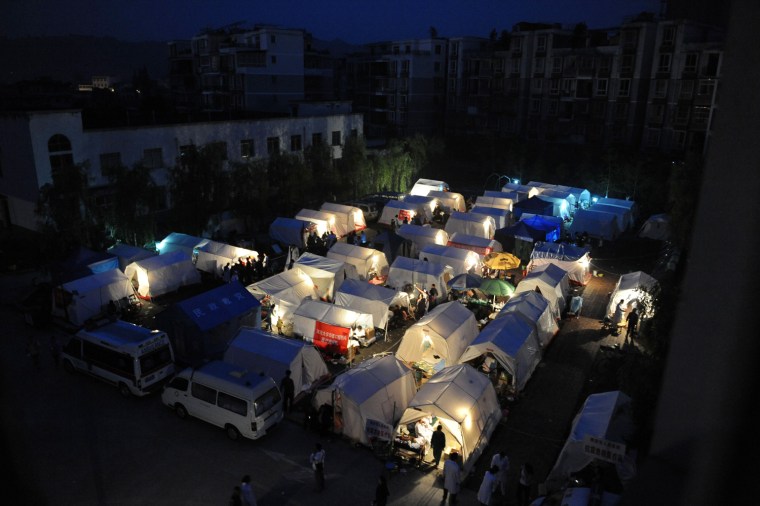 Image: Tents outside a hospital light up at night after Saturday's earthquake hit Lushan county