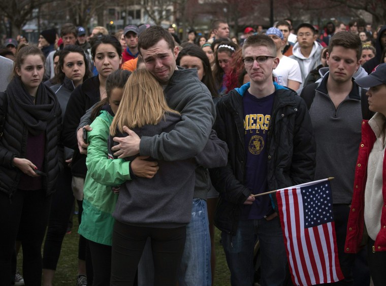 Image: Scott Turner is hugged by friends as he weeps at a vigil for bomb victims a day after two explosions hit the Boston Marathon in Boston