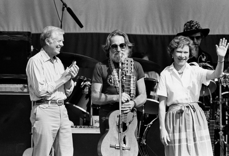 Willie Nelson, center, is shown on stage with former President Jimmy Carter and his wife Rosalynn Carter, following the singing of \"Amazing Grace,\" May 18, 1985 in Plains Ga. at Nelson's Plains Centennial Concert. (AP Photo/Ric Feld)