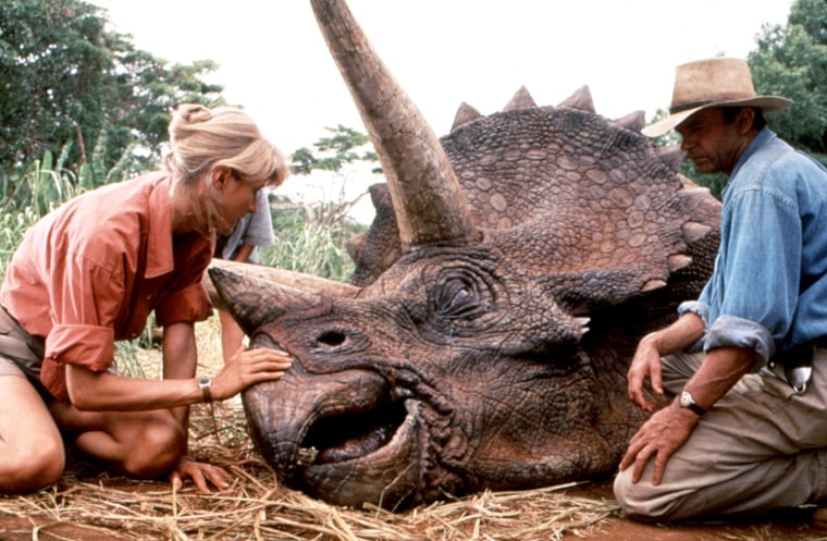 JURASSIC PARK, Laura Dern, Sam Neill, with triceratops, 1993, (c)MCA/courtesy Everett Collection