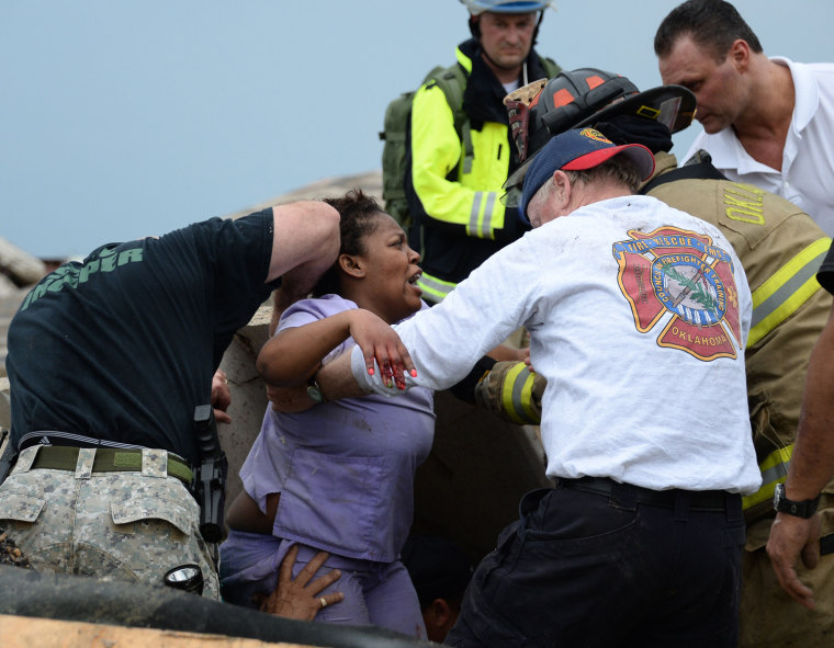Image: Rescue workers help free one of the 15 people that were trapped at a medical building at the Moore hospital complex in Moore