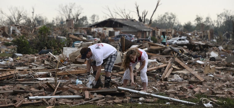 Image: A couple searches for belongings after a tornado struck Moore, Oklahoma