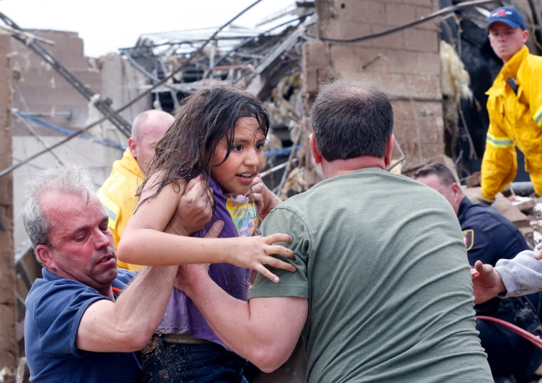 Image: A child is pulled from the rubble of the Plaza Towers Elementary