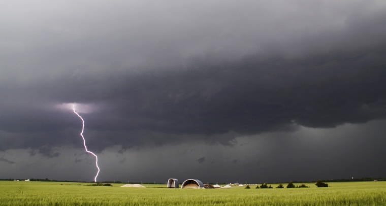 Image: Lightning from a tornadic thunderstorm passing over Clearwater, Kansas strikes at an open field
