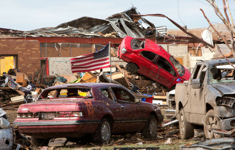 Image: Destroyed vehicles lie in the rubble outside the Plaza Towers Elementary school in Moore, Oklahoma