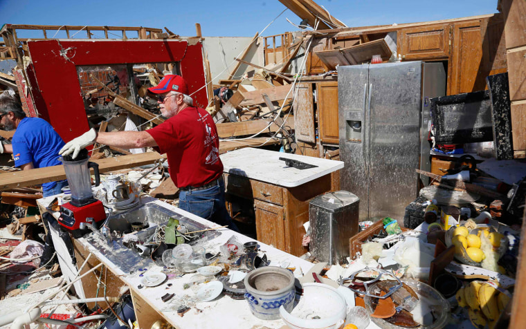 Image: Joe Bell recovers a mixer in his kitchen in his tornado-destroyed house in Oklahoma City