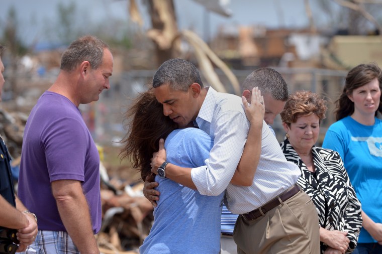 Image: Barack Obama is greeted as he tours a tornado affected area