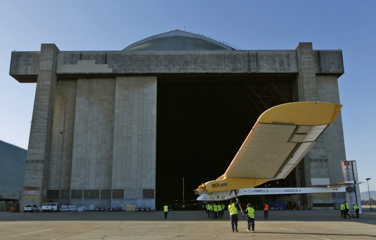 Image: Crew members return the Solar Impulse to its hangar following a test flight at Moffett Field in Mountain View