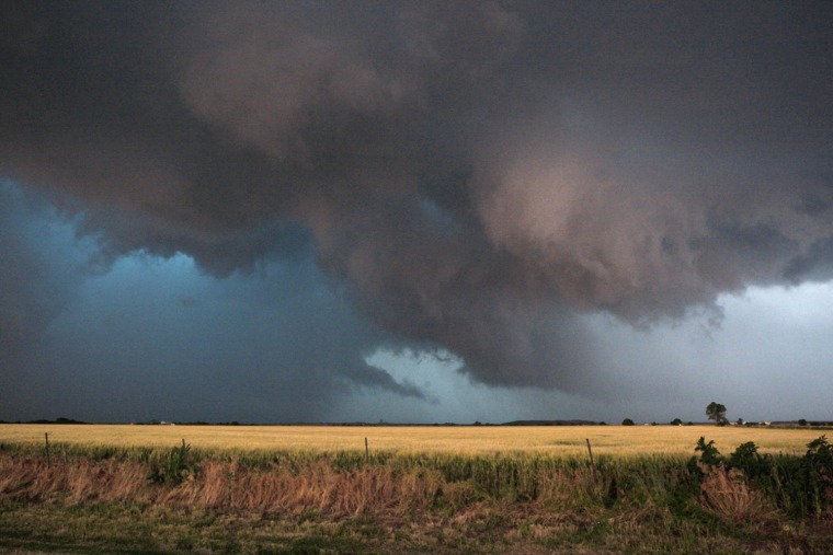 Image: Large clouds are seen as a tornado passes south of El Reno, Oklahoma