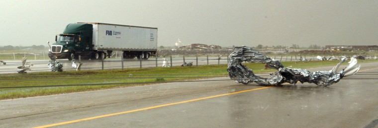 Image: Tornado debris and downed power lines are seen at Interstate-40 Westbound just east of El Reno, Oklahoma