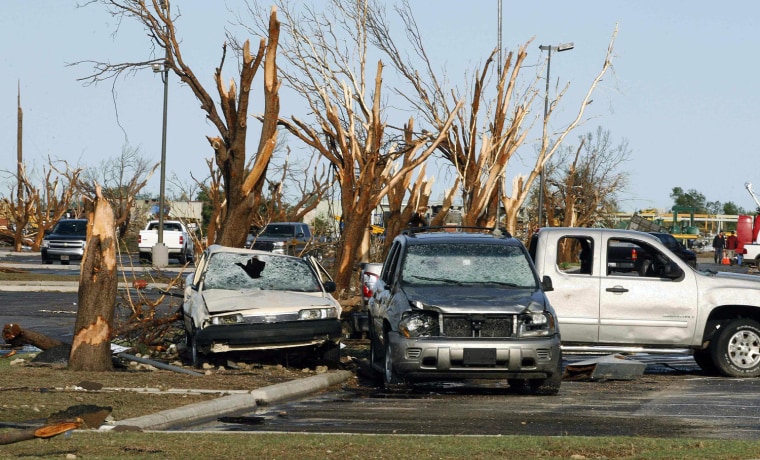 Image: Cars and trees damaged by a tornado are seen at Canadian Valley Technology Center in El Reno