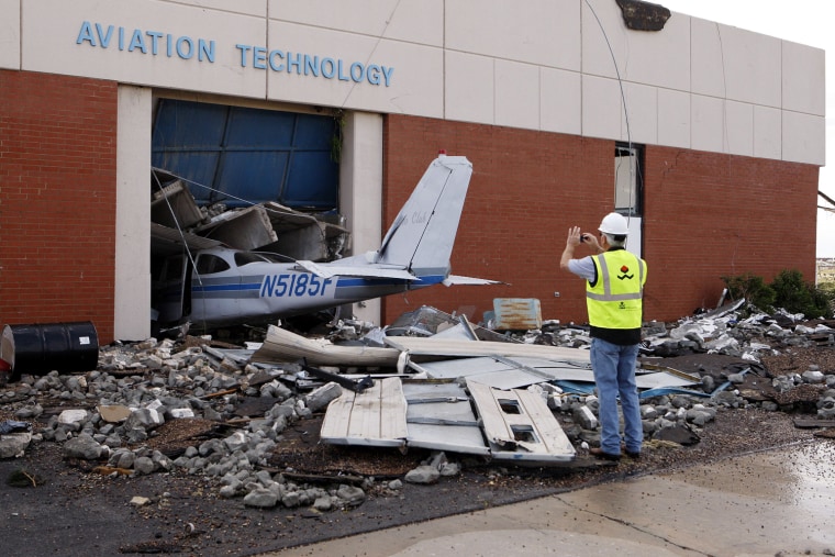 Image: Cary Dehart photographs tornado damage at Canadian Valley Technology Center's Aviation Technology building in El Reno