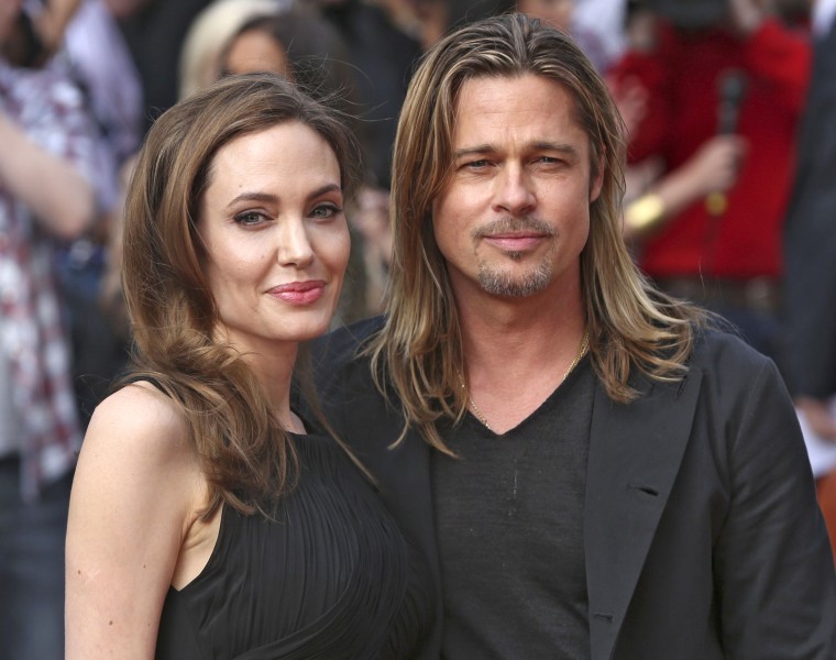 Image: Angelina Jolie poses with her fiance Brad Pitt as they arrive for the world premiere of his film World War Z in London