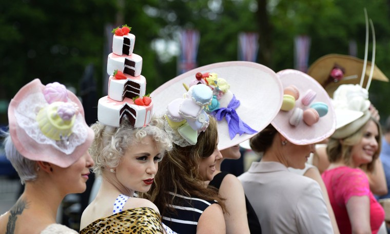 Image: Racegoers pose for photographers as they arrive for Ladies' Day at the Royal Ascot horse racing festival at Ascot