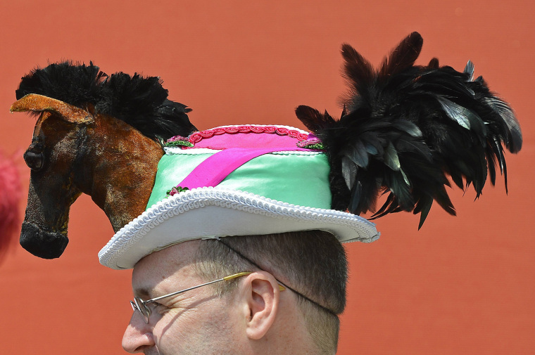 Image: Racegoer wears an equine-themed hat on the second day of the Royal Ascot horse racing festival at Ascot in southern England
