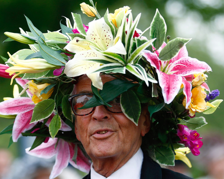 Image: A man wears a hat made of flowers on the first day of the Royal Ascot horse racing festival at Ascot