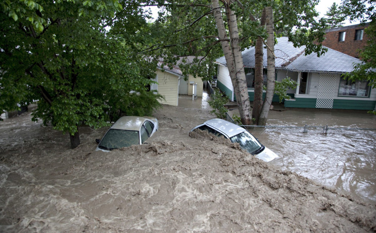 Image: Cars are submerged by the flood waters in High River, Alberta