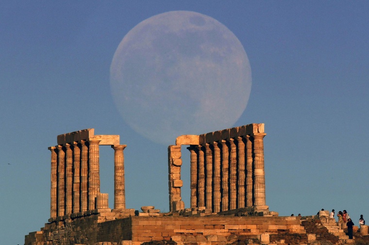 Image: The moon rises over the temple of Poseidon in Cape Sounion east of Athens