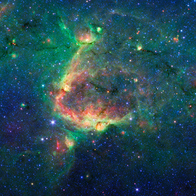 Image: This infrared image shows a striking example of what is called a hierarchical bubble structure, in which one giant bubble, carved into the dust of space by massive stars, has triggered the formation of smaller bubbles. The large bubble takes up the