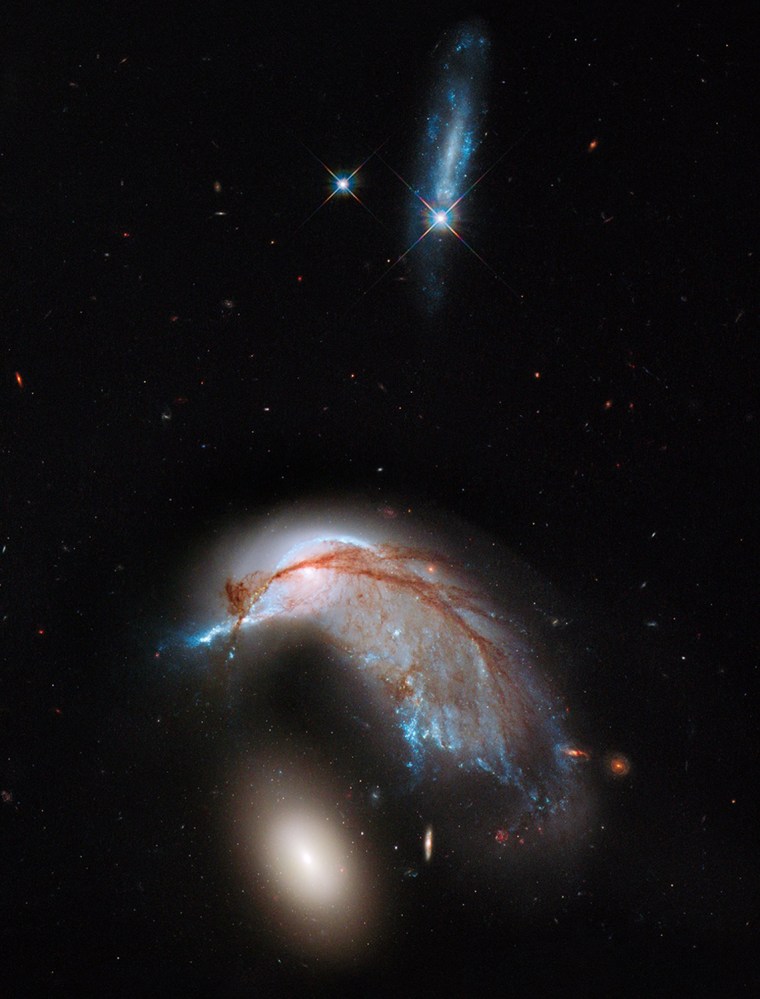Image: This NASA Hubble Space Telescope image, showing what looks like the profile of a celestial bird, belies the fact that close encounters between galaxies are a messy business