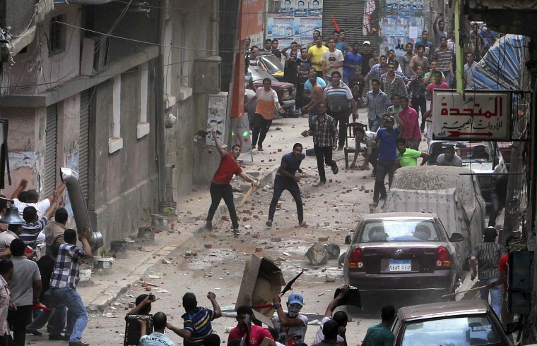 Image: Anti-Mursi protesters and residents of an area in Sidi Gaber, clash in a side street off a main street where a massive anti-Mursi protest is taking place, in Alexandria