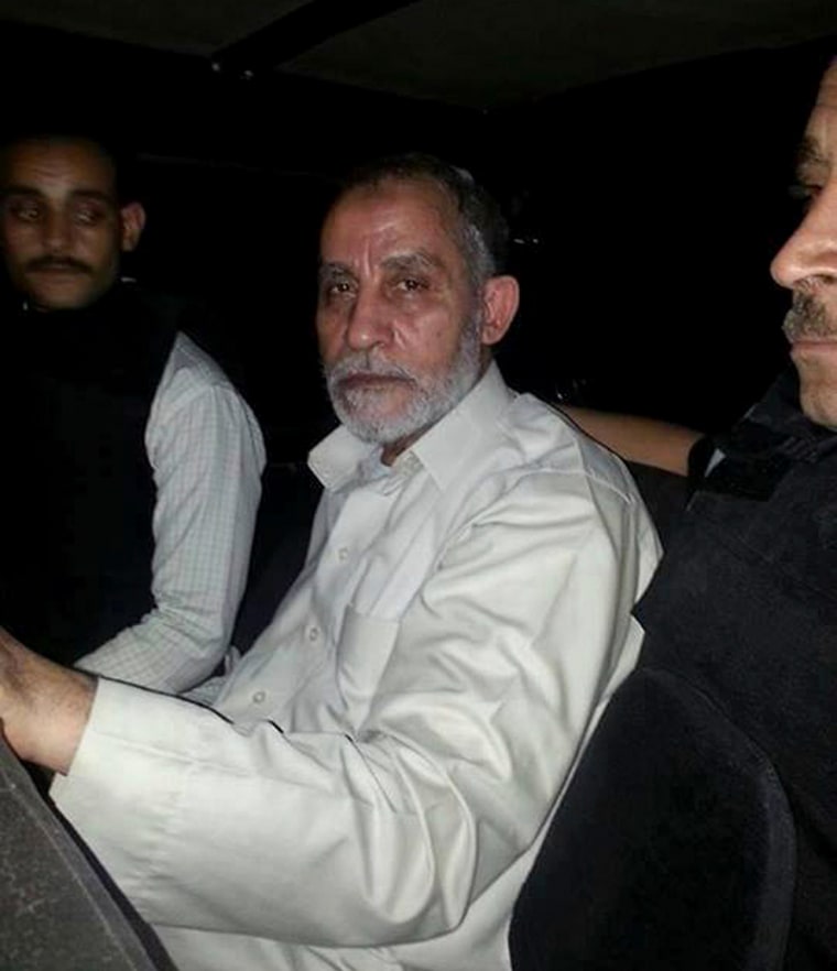 Image: Egyptian Interior Ministry handout shows Muslim Brotherhood leader Mohammed Badie sitting in a police vehicle after being arrested by security forces in Cairo