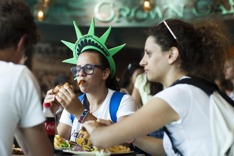 Image: A woman eats at a food court during the reopening of the Statue of Liberty and Liberty Island to the public in New York
