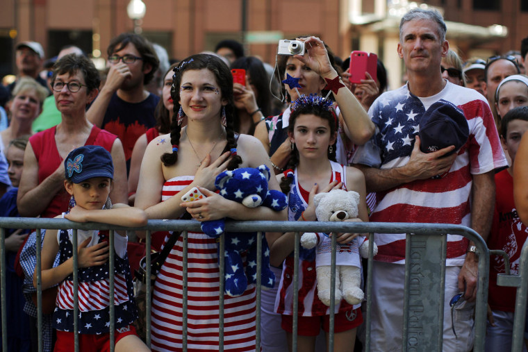 Image: The Haig family stands for the United States pledge of allegiance before a public reading the United States Declaration of Independence, part of Fourth of July Independence Day celebrations, in Boston
