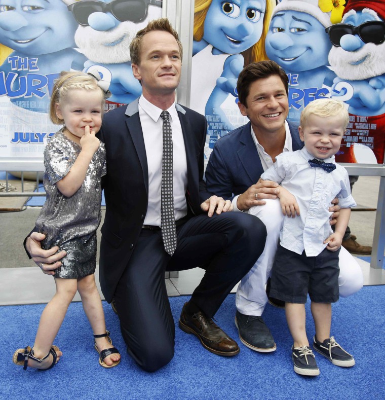 Image: Cast member Harris and partner Burtka pose with their twins Gideon Scott and Harper Grace at the premiere of the film \"The Smurfs 2\" at the Regency Village theatre in Los Angeles