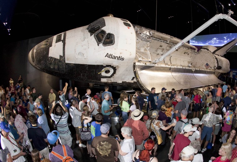 Image: Visitors view the space shuttle Atlantis on the opening day of exhibit at the Kennedy Space Center Visitor Complex in Cape Canaveral
