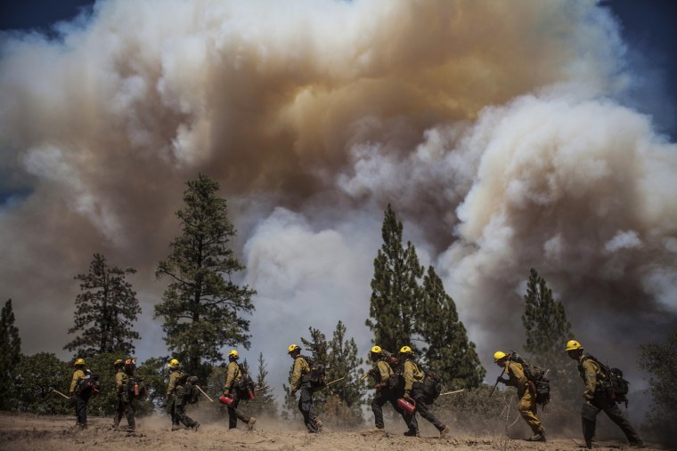 Image: Los Angeles County firefighters hike in on a fire line on the Rim Fire near Groveland