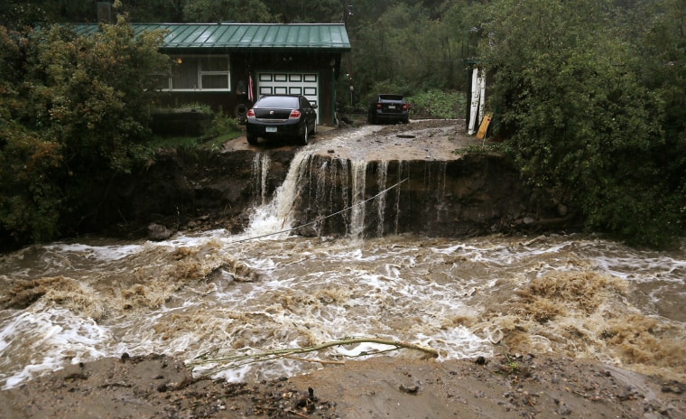 Image: A home and car are stranded after a flash flood in Coal Creek destroyed the bridge near Golden, Colorado