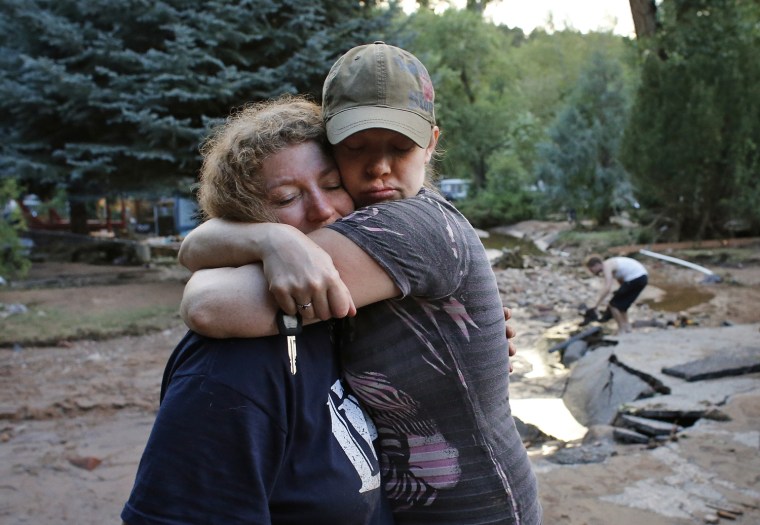 Image: Holly Rob, right, and her neighbor Pam Bowers hug after a day salvaging Rob's belongings from her flood-destroyed home, in Lyons, Colo., on Friday.