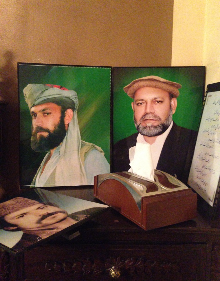 Portraits of Almas sit on a nightstand in his bedroom.