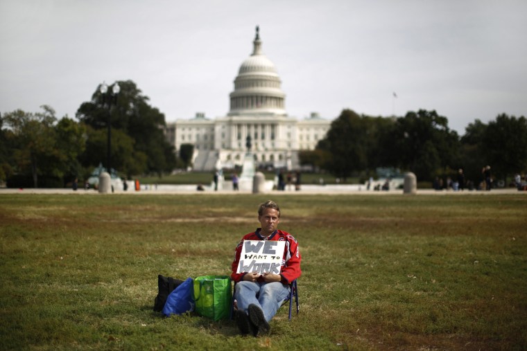 Image: Furloughed Americorps employee Wismer sits alone on the Washington Mall