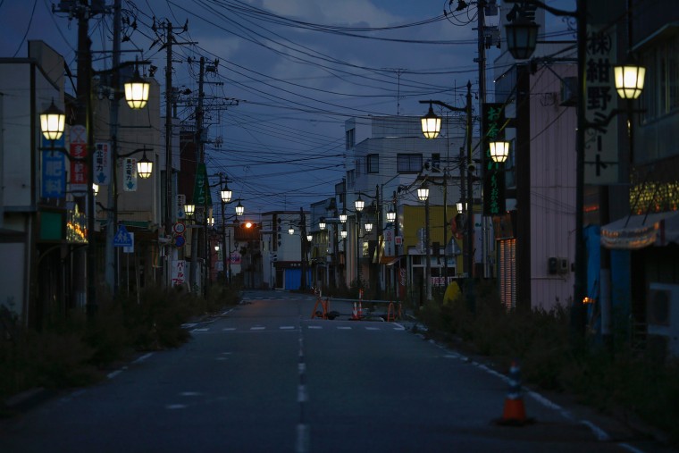 Image: Street lamps light the street in the evacuated town of Namie in Fukushima prefecture