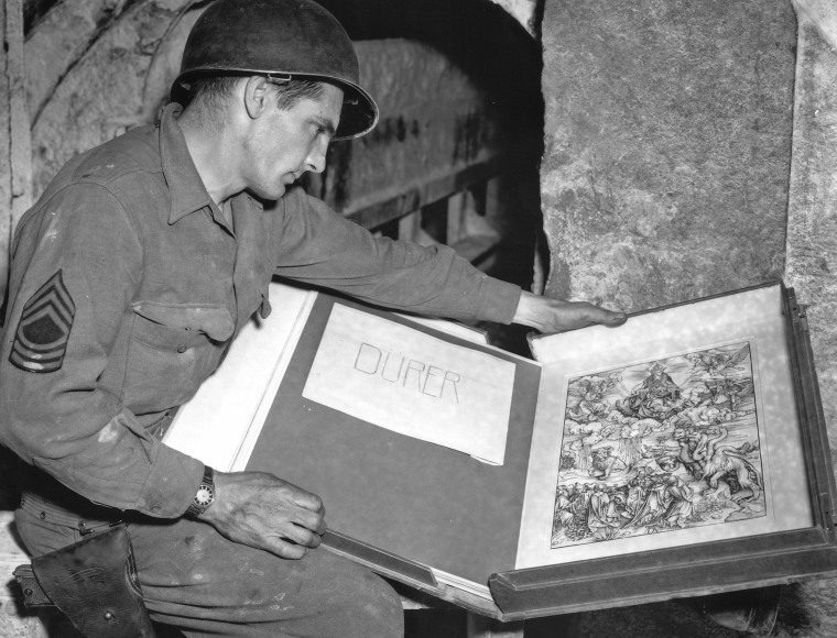 In this May 13, 1945 photo released by the U.S. National Archives,  U.S. Army Sgt. Harold Maus of Scranton, Pa., looks over an engraving by German artist Albrecht Durer, which was found among other art treasures at a salt mine in Merkers, Germany. Holocaust survivors and their relatives, as well as art collectors and museums, can go online beginning Monday, Oct. 18, 2010 to search a historical database of more than 20,000 art objects stolen in German-occupied France and Belgium from 1940 to 1944. (AP Photo/U.S. National Archives)