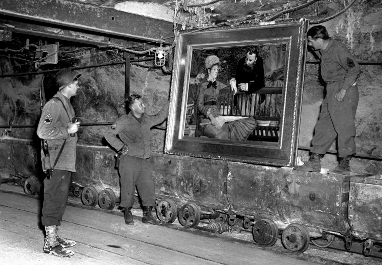 Undated black-and-white file photo of American soldiers looking at artwork German Nazis had stored in a Thuringian mine. They hold a painting of impressionist painter Edouard Manet (\"In the Wintergarden\", 1879) standing on lorries. People looking for Nazi art loot in U.S. museums are to get a new tool when a Web site - www.nepip.org - goes on line that will help make a quick search of important public collections. A searcher for a lost work may see a clue in a thumbnail photo and a brief description on the Internet. The museum can then be asked for more information on what art experts call provenance - the object's history, including how the museum got it. (AP Photo/National Archives)