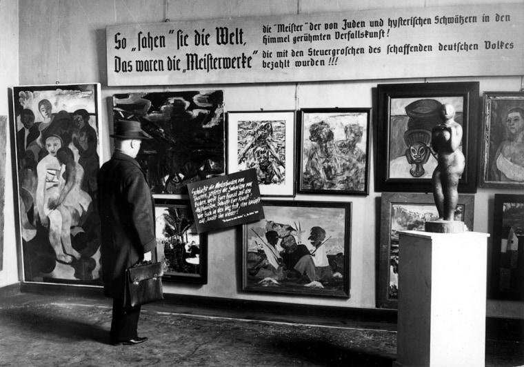 Image: A man looks at pieces from Nazi-curated travelling exhibition 'Degenerate Art' at the Haus der Kunst in Berlin
