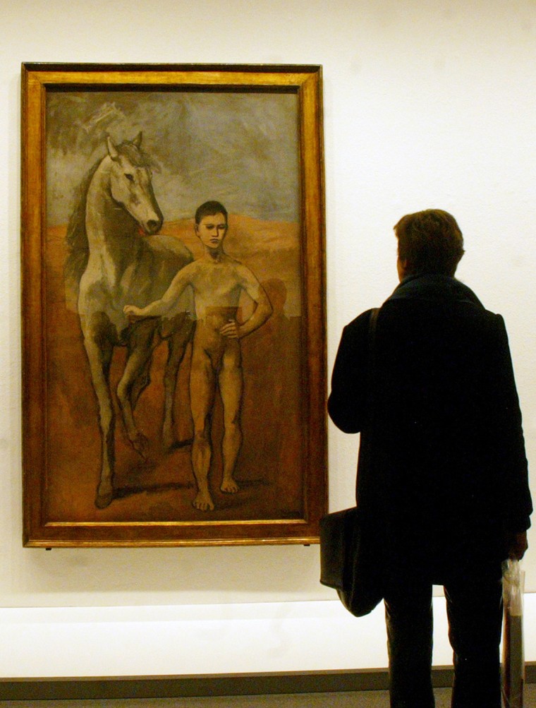**FILE** This Feb. 18, 2004 file photo shows a visitor looking at Pablo Picasso's painting \"Boy Leading a Horse\" at the New National Gallery in Berlin. Two leading New York City museums will remain the owners of this Picasso painting after settling claims by the heirs of a Jewish banker that the family was forced by the Nazis to sell the work of art. The settlement was announced in Manhattan federal court on Monday, Feb. 2, 2009 as the case was about to go to trial. (AP Photo/Franka Bruns, file)
